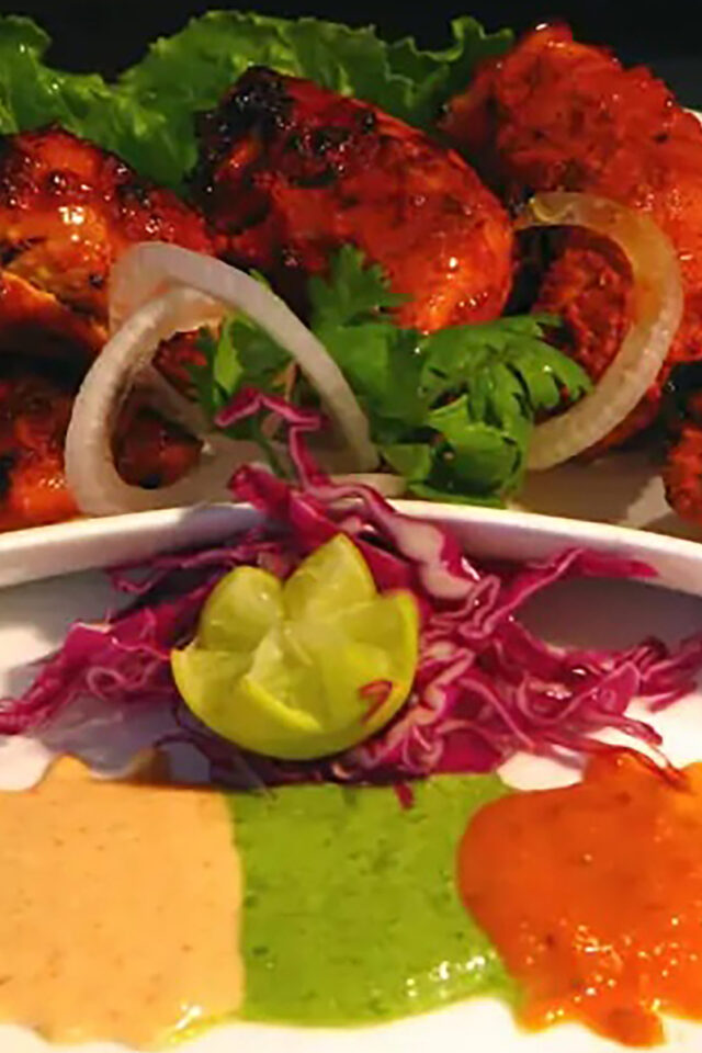 Behind the cooking of tandoori chicken best restaurant Crawley zari indian takeaway
