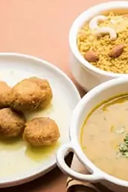 Traditional Rajasthani Dal Baati Churma served with hard wheat rolls, lentils, and rich ghee.
