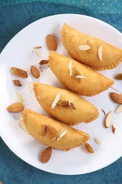 Crispy fried sweet Gujiya pastry dumplings filled with dried fruits at Zari Crawley.