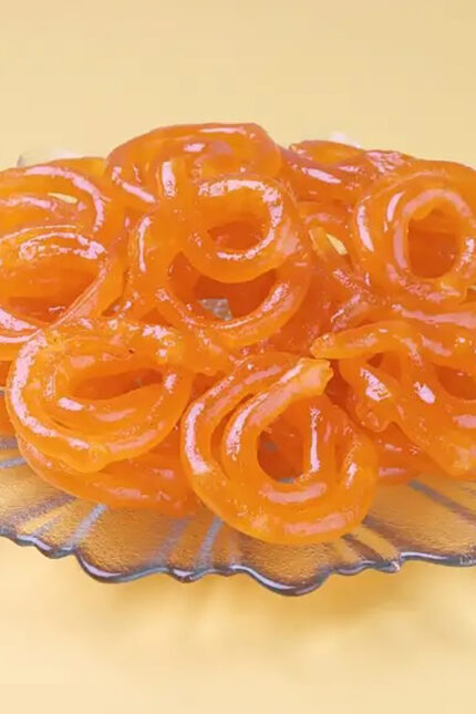 Crispy golden deep-fried Jalebi spirals in sugar syrup at Zari Restaurant Crawley.