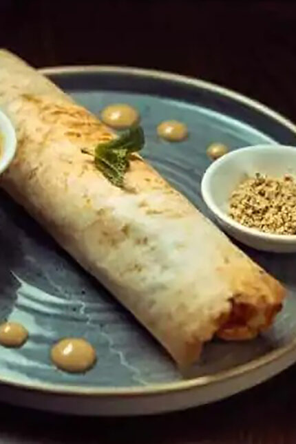 Authentic Indian flatbread wrap with dipping sauces at Zari Indian restaurant.