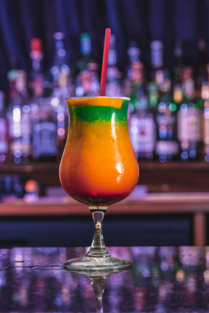 Vibrant multi-layered tropical rum cocktail served during bottomless brunch at Zari.